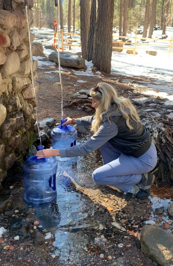 Filling jugs at Harding Spring in fall