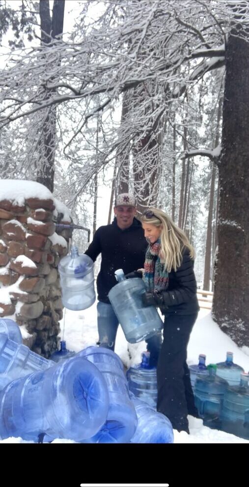 Collecting spring water in winter snow